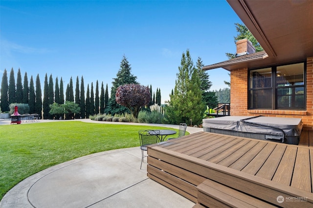 view of patio / terrace featuring a covered hot tub