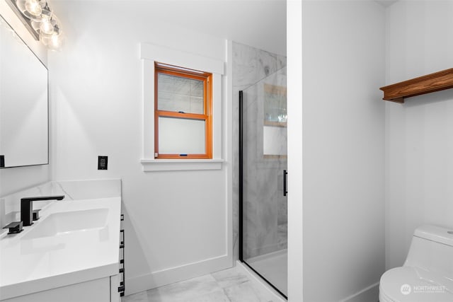 bathroom with vanity, toilet, and a shower with shower door