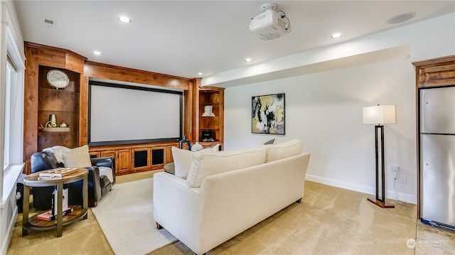 carpeted cinema room with plenty of natural light