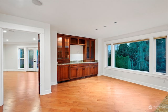 unfurnished living room with french doors and light wood-type flooring