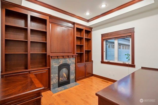 unfurnished living room with a high end fireplace, light hardwood / wood-style floors, and ornamental molding