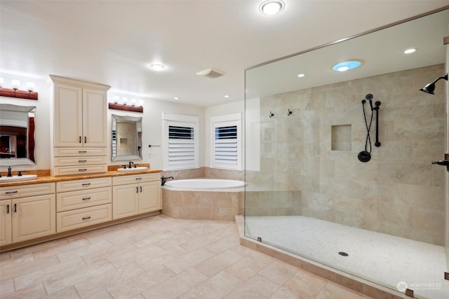 bathroom featuring vanity and shower with separate bathtub