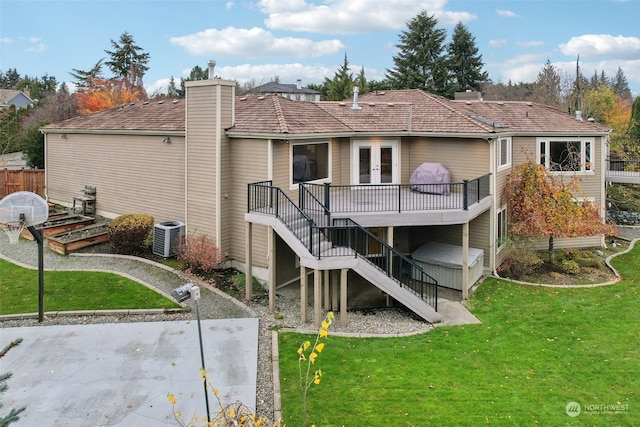 rear view of house with a lawn, central air condition unit, french doors, and a deck