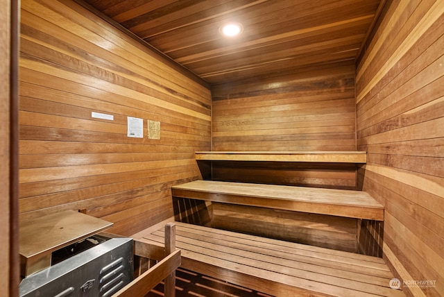 view of sauna featuring wooden walls and wooden ceiling