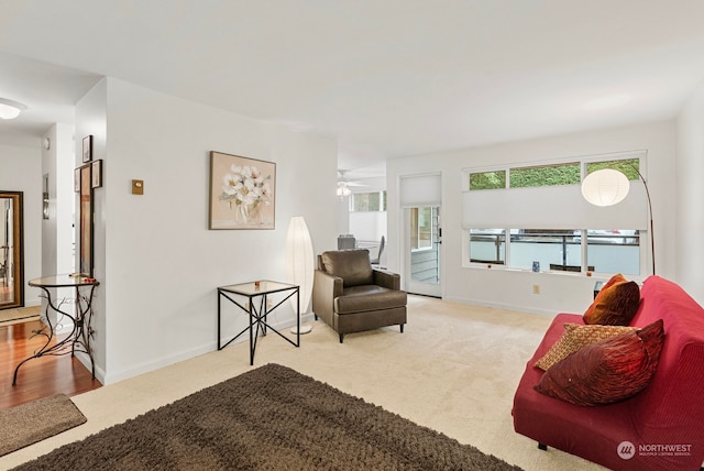 carpeted living room with ceiling fan