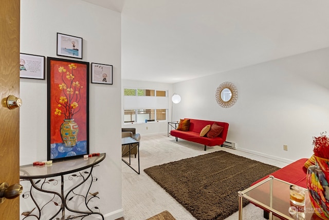 living room featuring carpet and a baseboard heating unit