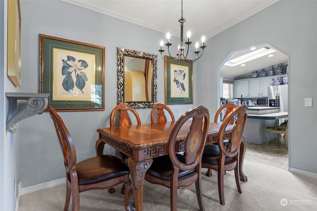 dining space featuring ornamental molding, an inviting chandelier, and light colored carpet