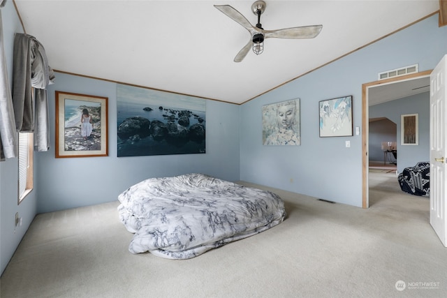 bedroom featuring ceiling fan, light colored carpet, and vaulted ceiling