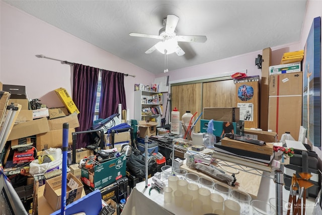 interior space featuring a textured ceiling, vaulted ceiling, and ceiling fan