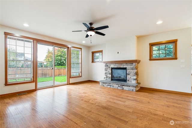 unfurnished living room with ceiling fan, plenty of natural light, and light hardwood / wood-style flooring