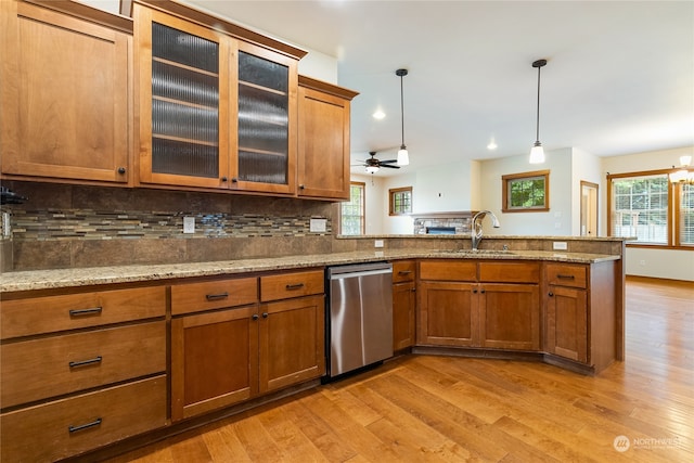 kitchen featuring ceiling fan with notable chandelier, decorative light fixtures, light hardwood / wood-style flooring, and plenty of natural light