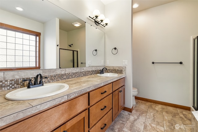 bathroom with decorative backsplash, vanity, an enclosed shower, and toilet