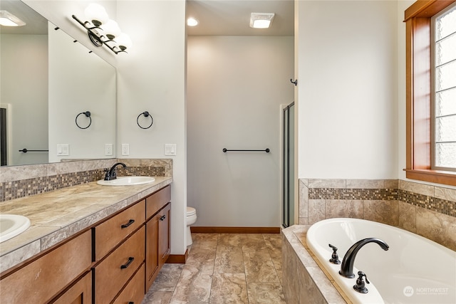 full bathroom with shower with separate bathtub, vanity, and toilet