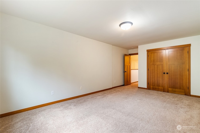 unfurnished bedroom with carpet and a closet