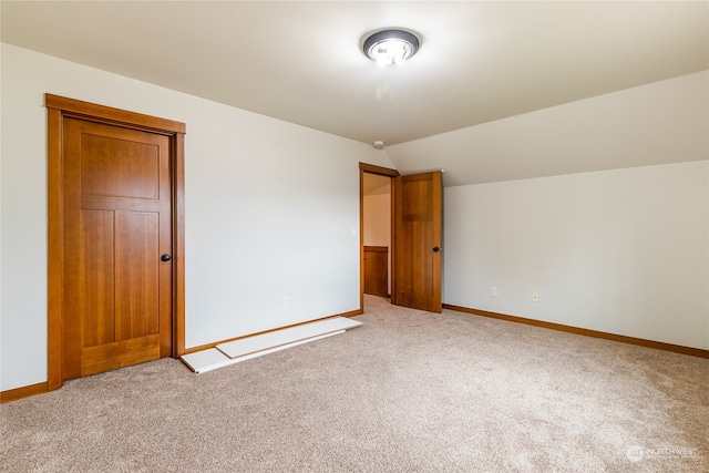 interior space with carpet flooring and lofted ceiling