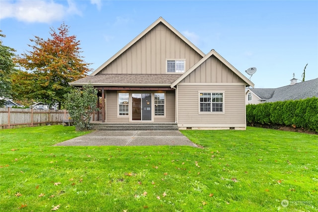 rear view of property featuring a yard and a patio