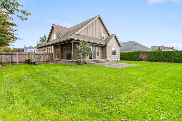 rear view of property featuring a yard and a patio