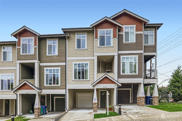 townhome / multi-family property featuring a balcony and a carport