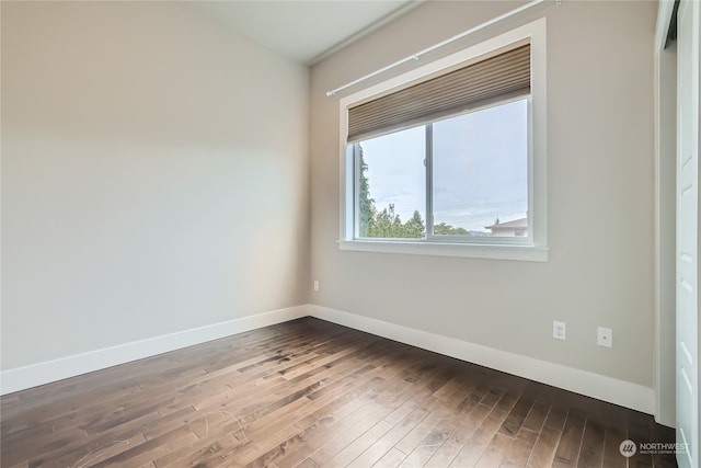 spare room with hardwood / wood-style floors