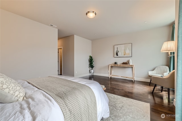 bedroom with a closet and dark hardwood / wood-style flooring