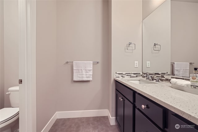 bathroom with vanity, toilet, and tile patterned floors