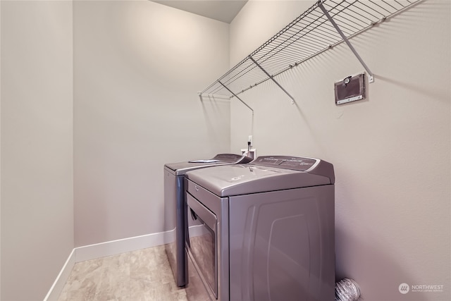 clothes washing area featuring separate washer and dryer