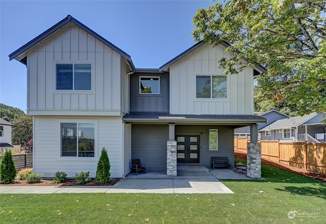 rear view of property with a yard and a patio area