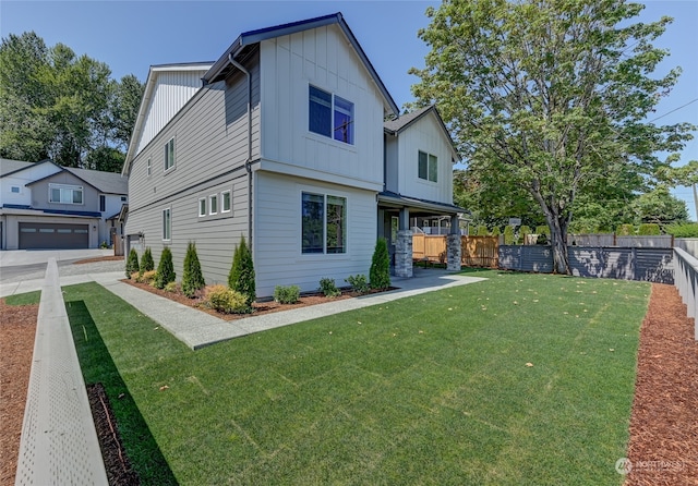 view of front of home featuring a front yard and a garage