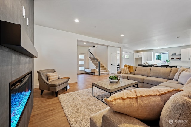 living room featuring light hardwood / wood-style flooring and a fireplace