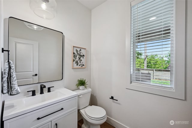 bathroom featuring vanity and toilet