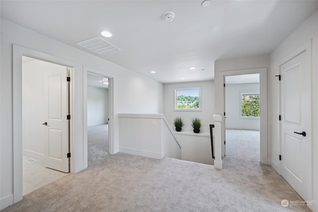 interior space featuring light carpet