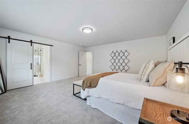 bedroom featuring a barn door and carpet