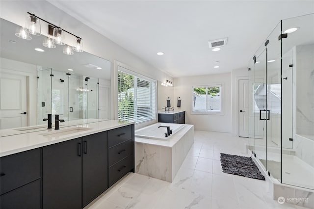 bathroom with vanity, a healthy amount of sunlight, and shower with separate bathtub