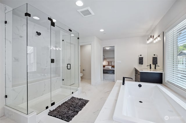 full bathroom featuring vanity, toilet, and independent shower and bath