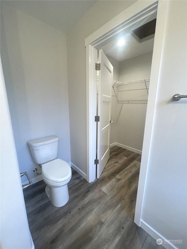 bathroom with toilet and hardwood / wood-style flooring