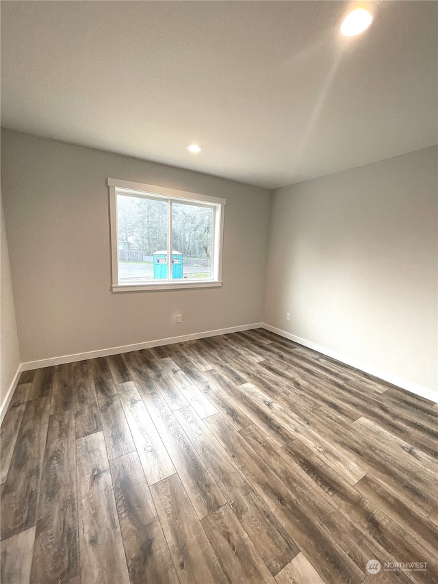 spare room with dark hardwood / wood-style flooring