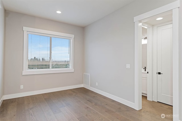 unfurnished room with light hardwood / wood-style flooring