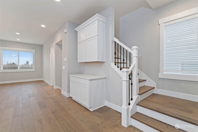 stairs featuring hardwood / wood-style flooring