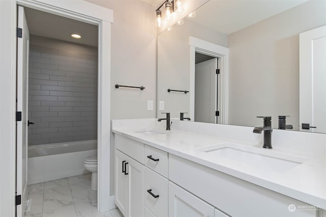 full bathroom featuring toilet, tiled shower / bath, and vanity