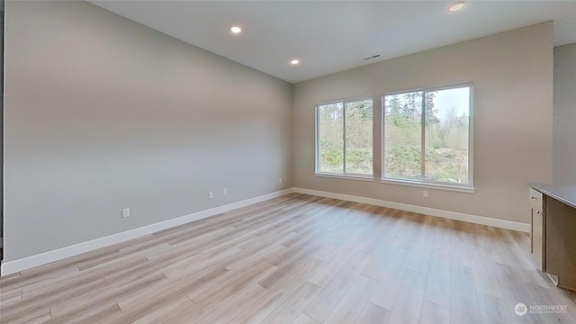 spare room with light wood-type flooring