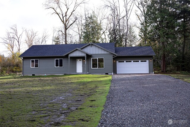 ranch-style home featuring a garage and a front yard