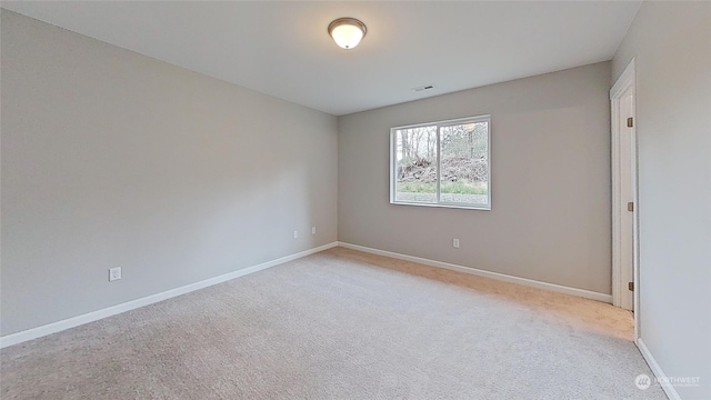 empty room with light colored carpet