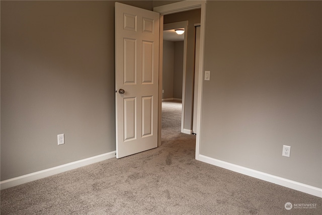 spare room featuring light carpet