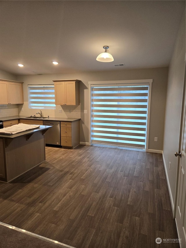 kitchen with dishwasher, sink, gray cabinetry, backsplash, and dark hardwood / wood-style flooring