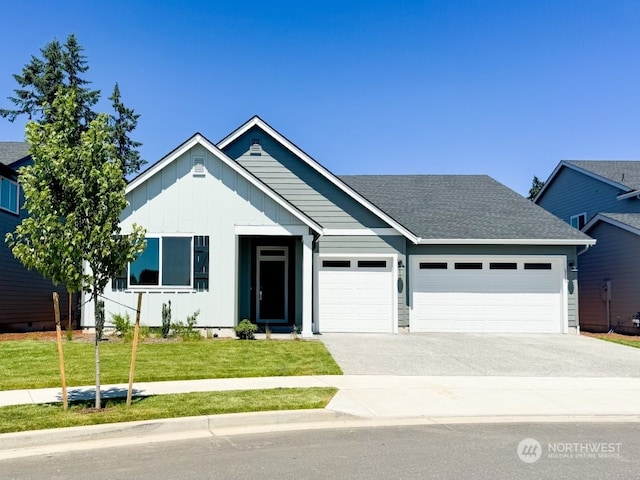 view of front of home with a garage and a front lawn