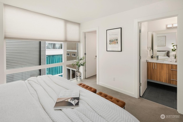 carpeted bedroom with ensuite bath