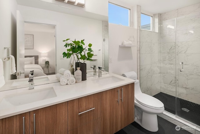 bathroom with vanity, a shower with shower door, and toilet