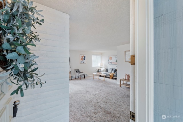 carpeted living room featuring a textured ceiling