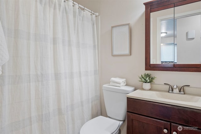 bathroom featuring vanity, toilet, and a shower with shower curtain