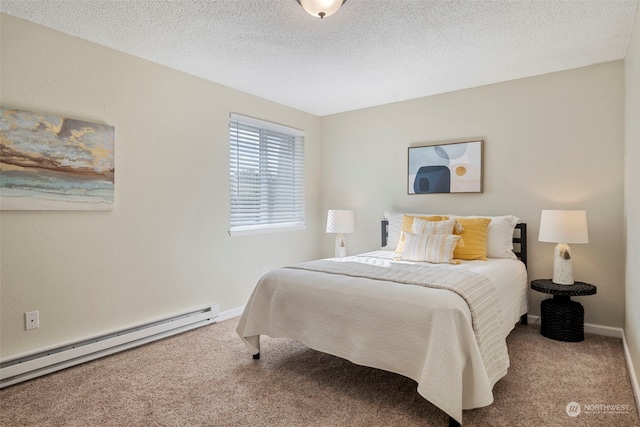 bedroom with carpet, a baseboard heating unit, and a textured ceiling